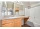 Bathroom with single vanity, shower-tub combo and large mirror at 4891 E Meadow Mist Ln, San Tan Valley, AZ 85140