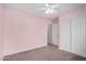 A pink bedroom offers a ceiling fan, and a closet for storage at 4891 E Meadow Mist Ln, San Tan Valley, AZ 85140