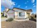 Attractive single-story home with desert landscaping, a two-car garage, and a well-manicured lawn at 4891 E Meadow Mist Ln, San Tan Valley, AZ 85140
