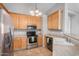 A well-lit kitchen with stainless steel appliances and light wood cabinetry at 4891 E Meadow Mist Ln, San Tan Valley, AZ 85140