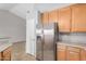 Modern kitchen design with stainless steel refrigerator and light wood cabinets at 4891 E Meadow Mist Ln, San Tan Valley, AZ 85140