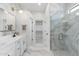 Modern bathroom featuring marble floors and walls, a double vanity, and a walk-in shower at 4960 E Colonial Dr, Chandler, AZ 85249