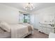 Inviting bedroom with a ceiling light, window views, and a classic dresser with mirror at 4960 E Colonial Dr, Chandler, AZ 85249
