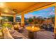 Cozy covered patio featuring an outdoor kitchen, seating area, and view of the pool at 4960 E Colonial Dr, Chandler, AZ 85249