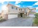 Inviting home exterior featuring a three-car garage and meticulously landscaped front yard at 4960 E Colonial Dr, Chandler, AZ 85249
