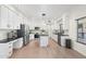 Modern white kitchen features stainless steel appliances, black countertops, and ample cabinet space at 4960 E Colonial Dr, Chandler, AZ 85249