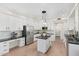 Modern kitchen with white cabinetry, stainless steel appliances, and center island with a pendant light at 4960 E Colonial Dr, Chandler, AZ 85249