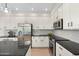 Bright kitchen with stainless steel appliances, ample cabinet space, and sleek black countertops at 4960 E Colonial Dr, Chandler, AZ 85249