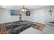 Spacious living room with ceiling fan, TV, and cozy gray sofa at 4960 E Colonial Dr, Chandler, AZ 85249
