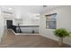 Bright loft space featuring wood floors, black banister, and modern lighting fixtures at 4960 E Colonial Dr, Chandler, AZ 85249