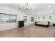 Luxurious bedroom featuring a chandelier, hardwood floors, and bright windows at 4960 E Colonial Dr, Chandler, AZ 85249