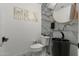 Stylish powder room with marble accent wall and unique sink at 4960 E Colonial Dr, Chandler, AZ 85249