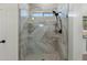 Modern shower with marble tiles, glass door, and rainfall shower head at 4960 E Colonial Dr, Chandler, AZ 85249
