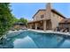 Expansive backyard featuring a large pool, patio, and lush greenery, perfect for outdoor living and entertaining at 5672 E Beverly Ln, Scottsdale, AZ 85254
