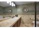 Elegant bathroom featuring a spacious vanity, decorative mirrors, and stylish tile work at 5672 E Beverly Ln, Scottsdale, AZ 85254