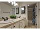 Bathroom featuring double sinks, a large mirror, and a shower with a blue decorative shower curtain at 5672 E Beverly Ln, Scottsdale, AZ 85254