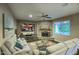 Comfortable living room featuring a stone fireplace, large windows, and plush seating for relaxing at 5672 E Beverly Ln, Scottsdale, AZ 85254