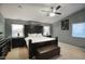 Spacious main bedroom featuring a dark wood bed frame, carpeted floors, and soft, natural lighting at 5672 E Beverly Ln, Scottsdale, AZ 85254