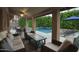 Covered patio with comfortable seating and a view of the backyard pool and lush greenery at 5672 E Beverly Ln, Scottsdale, AZ 85254