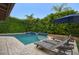 Beautiful pool with lounge chairs and lush green landscaping, creating a serene outdoor retreat at 5672 E Beverly Ln, Scottsdale, AZ 85254