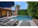 Beautiful pool with lounge chairs, lush landscaping, patio, and outdoor furniture creating an inviting outdoor space at 5672 E Beverly Ln, Scottsdale, AZ 85254
