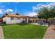 Landscaped backyard with artificial grass area and outdoor seating, ideal for relaxing and entertaining at 5808 W Acoma Dr, Glendale, AZ 85306