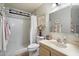 Bright bathroom featuring shower over tub, and vanity with a framed mirror and vanity at 5808 W Acoma Dr, Glendale, AZ 85306