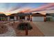 Charming single-story home with desert landscaping, solar panels, and a two-car garage at 5808 W Acoma Dr, Glendale, AZ 85306