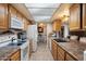 Well-lit kitchen with essential appliances and open layout, seamlessly connecting to the adjacent dining area at 5808 W Acoma Dr, Glendale, AZ 85306