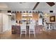 Bright kitchen with breakfast bar and seating area, open to the dining room, and decorated with decorative plates at 5808 W Acoma Dr, Glendale, AZ 85306
