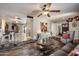 Bright living room opens to the dining room and features tile floors and layered decor at 5808 W Acoma Dr, Glendale, AZ 85306