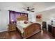 Serene main bedroom with hardwood floors, ceiling fan, and decor, creating a comfortable retreat at 5808 W Acoma Dr, Glendale, AZ 85306