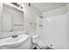 Bright bathroom features a white sink, toilet, and shower at 6313 W Carol Ave, Glendale, AZ 85302