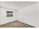 Bright bedroom features a window, neutral paint, and carpeted floors at 6313 W Carol Ave, Glendale, AZ 85302