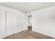 Cozy bedroom boasts neutral carpet and ample closet space with sliding doors at 6313 W Carol Ave, Glendale, AZ 85302