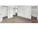 Spacious bedroom boasts neutral carpet with a doorway, and white walls at 6313 W Carol Ave, Glendale, AZ 85302