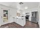 Updated kitchen with stainless steel appliances, white cabinets, and a convenient breakfast bar at 6313 W Carol Ave, Glendale, AZ 85302