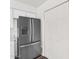 Modern kitchen featuring a stainless steel refrigerator and white cabinetry, offering ample storage at 6313 W Carol Ave, Glendale, AZ 85302