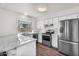 Updated kitchen featuring granite countertops and stainless steel appliances at 6313 W Carol Ave, Glendale, AZ 85302