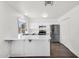 Bright kitchen featuring white cabinets, stainless steel appliances, and a breakfast bar at 6313 W Carol Ave, Glendale, AZ 85302
