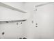 Clean, functional laundry room with shelving and a white door to the outside at 6313 W Carol Ave, Glendale, AZ 85302