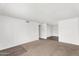 Open-concept living room features neutral carpet, freshly painted walls, and ample space for furniture at 6313 W Carol Ave, Glendale, AZ 85302