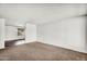 Spacious living room with carpet, freshly painted walls, and lots of natural light at 6313 W Carol Ave, Glendale, AZ 85302