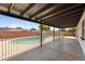 View of the pool from covered patio with wood-finished ceiling at 6313 W Carol Ave, Glendale, AZ 85302