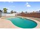 View of backyard pool showing updated plaster, with a rock surround and fencing at 6313 W Carol Ave, Glendale, AZ 85302