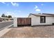 View of the low maintenance front yard featuring a privacy wall and gate at 6313 W Carol Ave, Glendale, AZ 85302