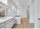 Spa-like bathroom featuring double vanities, soaking tub, and glass-enclosed shower at 8426 W Solano Dr, Glendale, AZ 85305