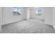 Bright bedroom with two large windows, neutral carpet, and ample natural light at 8426 W Solano Dr, Glendale, AZ 85305