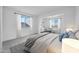 Bright bedroom with large windows, neutral decor, and a comfortable bed at 8426 W Solano Dr, Glendale, AZ 85305