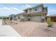Charming two-story home with a brick driveway and a three-car garage at 8426 W Solano Dr, Glendale, AZ 85305